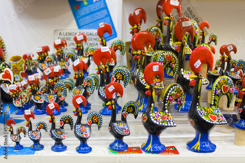 Traditional ceramic sculptures from Portugal, named Cork of Barcelos in souvenir store of Coimbra photo