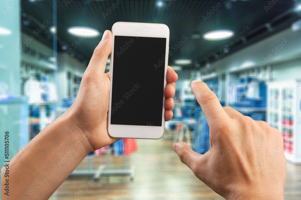 Clothing Store, Female Using Smartphone with blank screen