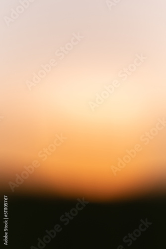 Blurred background image in orange and yellow gradient. © bios48