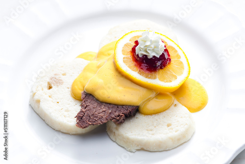 sirloin cream sauce with dumplings served with lemon, cranberries and whipped cream