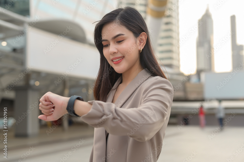 Businesswoman is using Smart watch in Modern city , business technology , city lifestyle concept