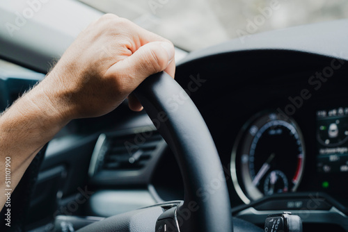 Male hands on a car's steering wheel © bizoo_n