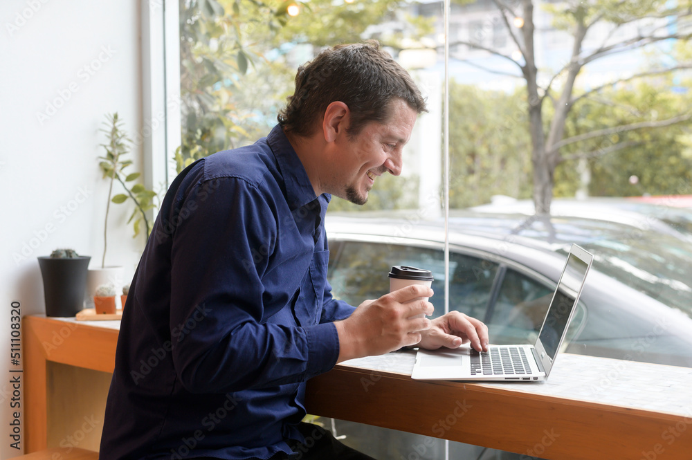 Fototapeta premium Portrait of business caucasian man in coffee shop