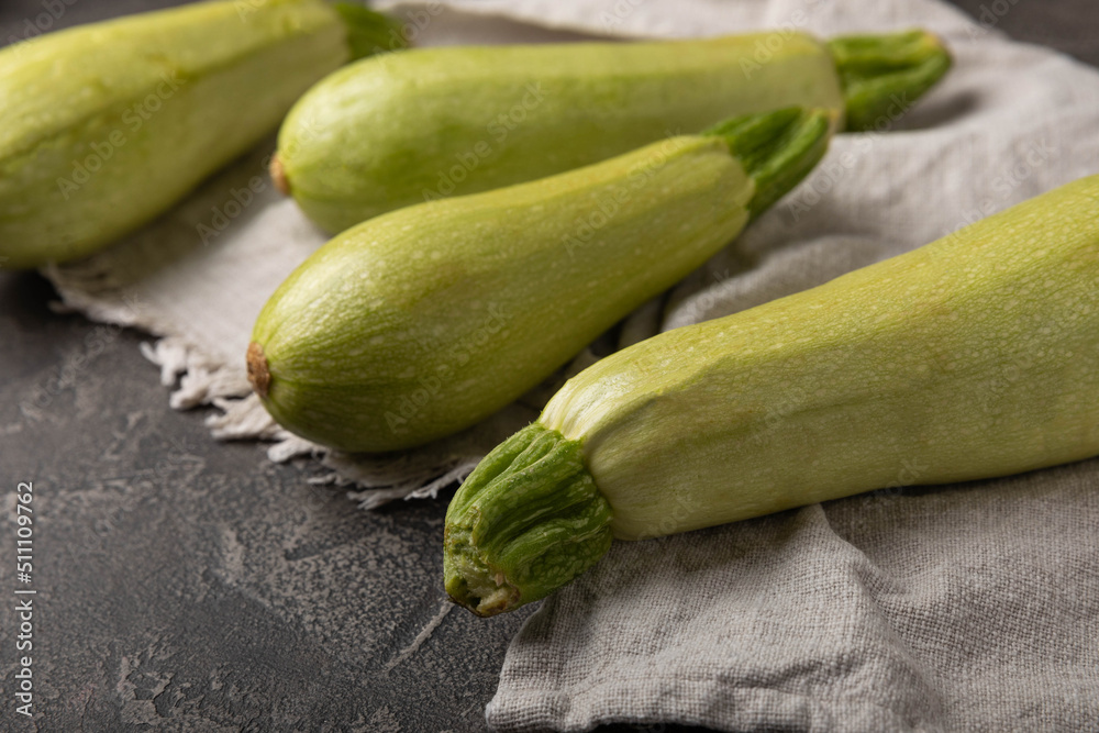 Squash vegetable marrow zucchini on black texture background.Vegetarian organic vegetables.Healthy food.Copy space.Place for text Squash vegetable marrow zucchini on black texture background.Vegetarian organic vegetables.Healthy food.Copy space.Place for text