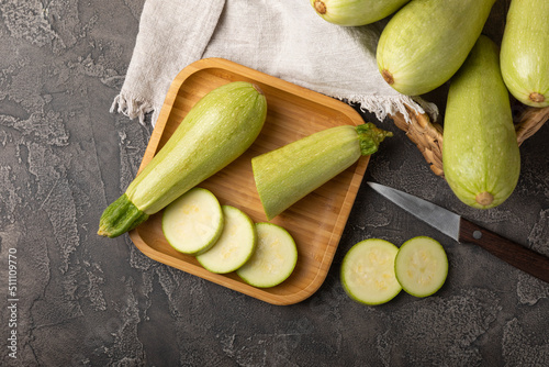 фотографія Slices of squash vegetable marrow zucchini on black texture background