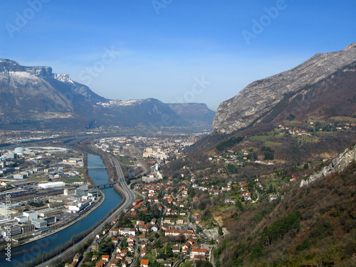 Grenoble. View of the city from above from a great height from the Bastille fortress. Mountains with snow, Isere river, roofs of houses, roads. France 2009 