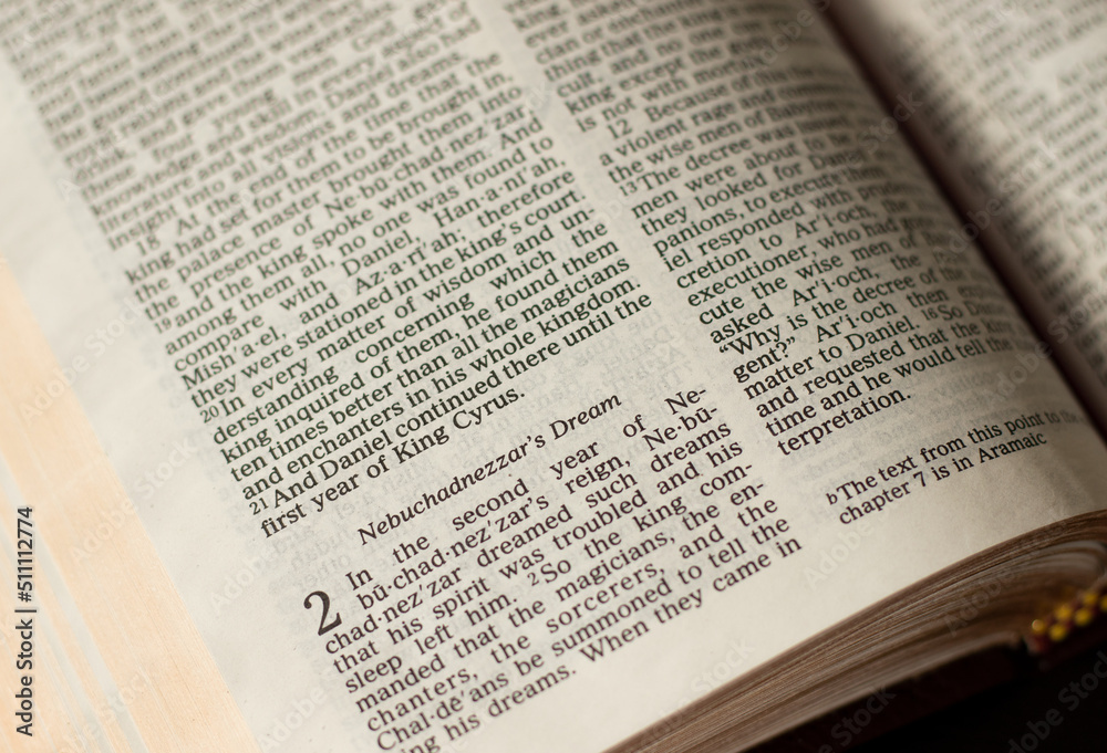 Nebuchadnezzar dream chapter in an open Holy Bible Book. A closeup. Studying Old Testament Book of prophet Daniel. Biblical concept. Nebuchadnezzar dream chapter in an open Holy Bible Book. A closeup. Studying Old Testament Book of prophet Daniel. Biblical concept.