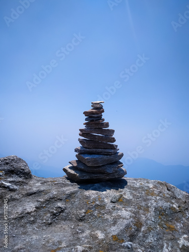 A tower of stone built from small pieces of stones on top of a mountain.