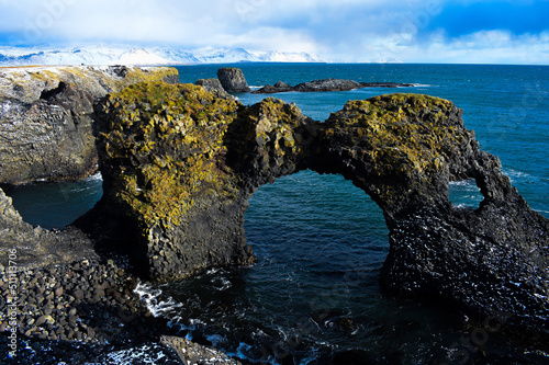 Panoramic view of Gatklettur natural arch rock in the ocean near Hellnar on Snaefellsnes Peninsula in Iceland photo