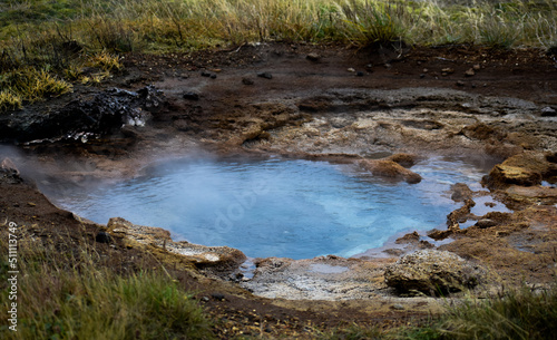 blue hot water from smoking geyser in Iceland