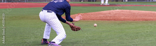 Baseball third baseman making a play on the infield photo