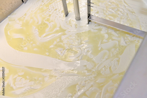 Artisan production of cheese, curd cutting and whey in the factory's vat. photo