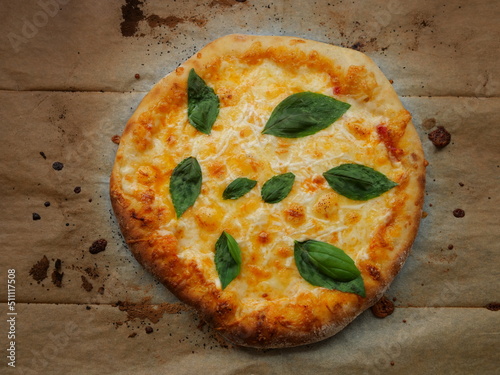 Cheese pizza with basil leaves