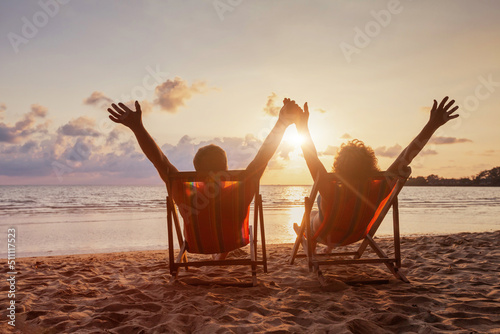Leinwand Poster beach holidays, happy retired couple enjoying sunset near the sea, holding hands