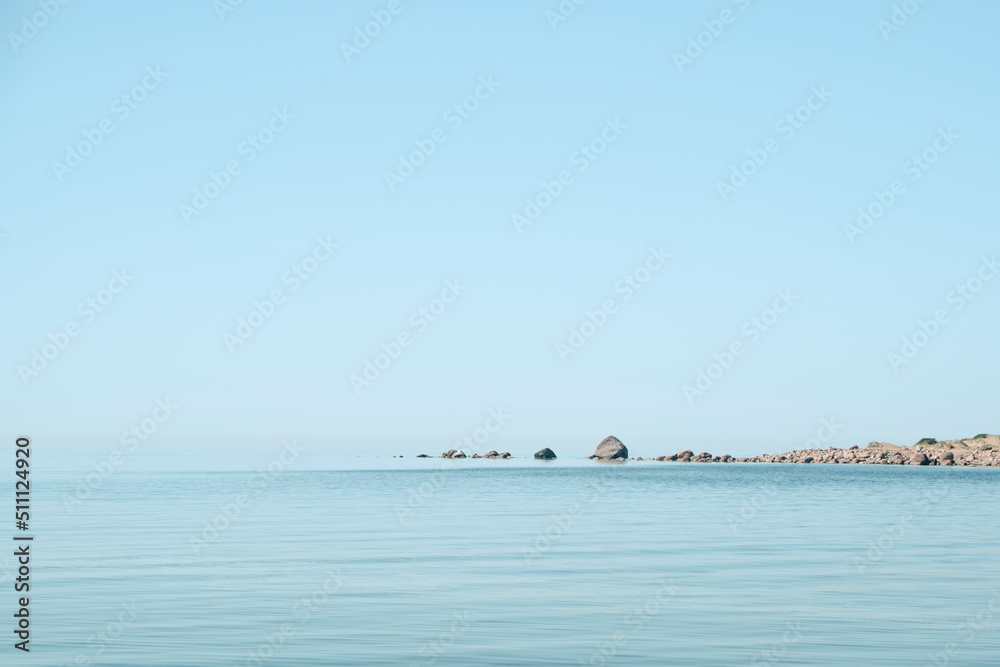 Seascape. Blue sky. Stones in the sea. High quality photo