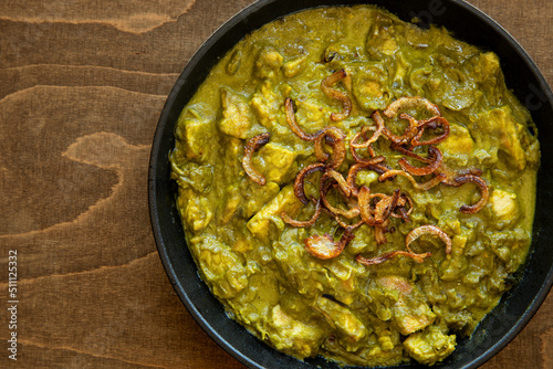 Turkey meat in coriander chutney with fried onion. Indian cuisine dish.
