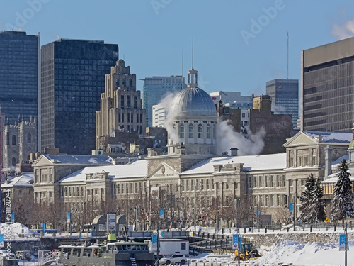 Old port of Montreal, with  Bonsecours market, with skyscrapers of downtown Montreal, Quebec, Canada on a sunny winter day with clear blue sky  photo