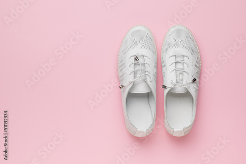 Summer women's sports style shoes on a pink background. Minimal concept of beauty and sports.