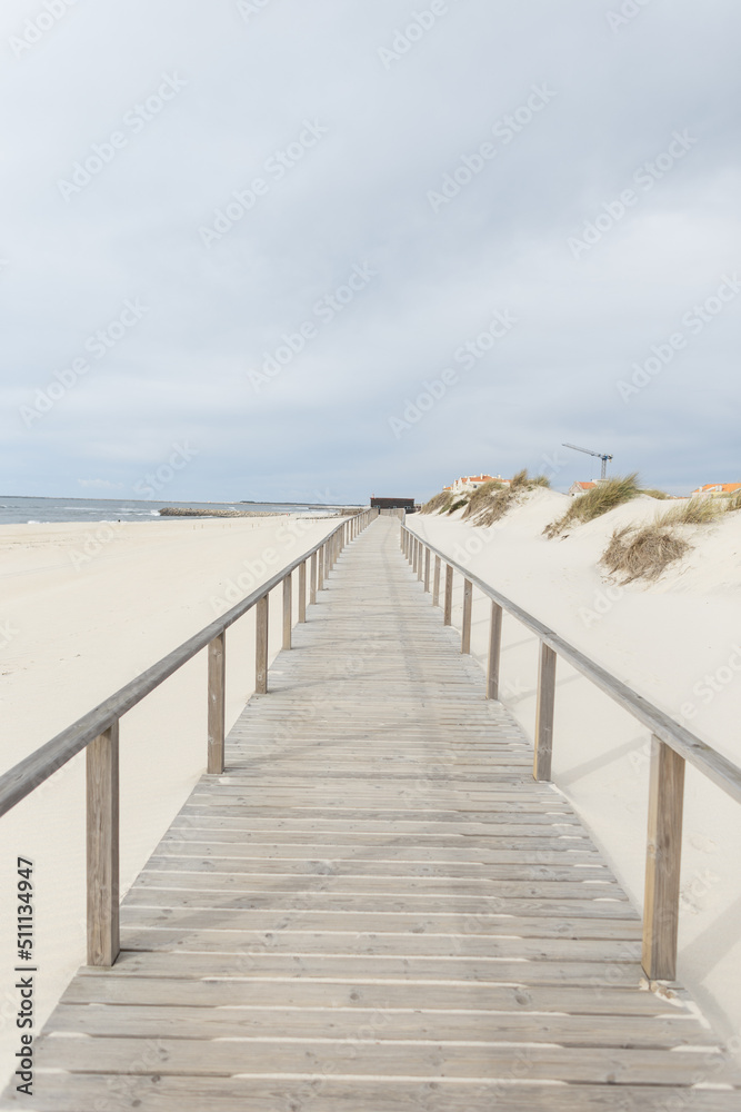 wooden walkway on the beach along the ocean