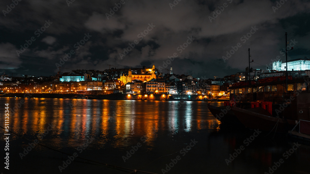 Beautiful European old night town of Porto near the river. Vintage city of Porto, Portugal with lights