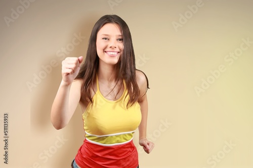 Smiling beautiful woman pointing finger, congratulating, praising you, standing over background