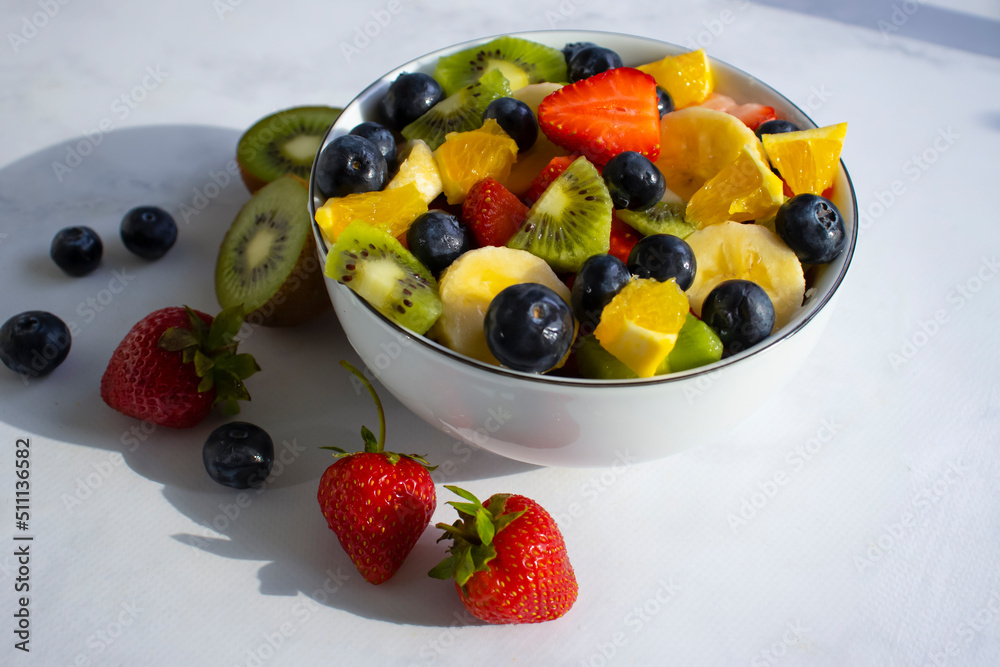Plate with fruit salad on a light background Plate with fruit salad on a light background
