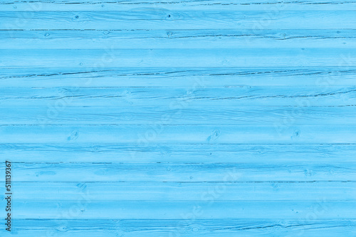 Blue background. Old wooden wall cracked from time to time painted blue.