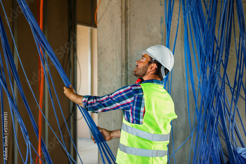 Εκτύπωση καμβά A skilled electrician in construction checking cables for building electric network