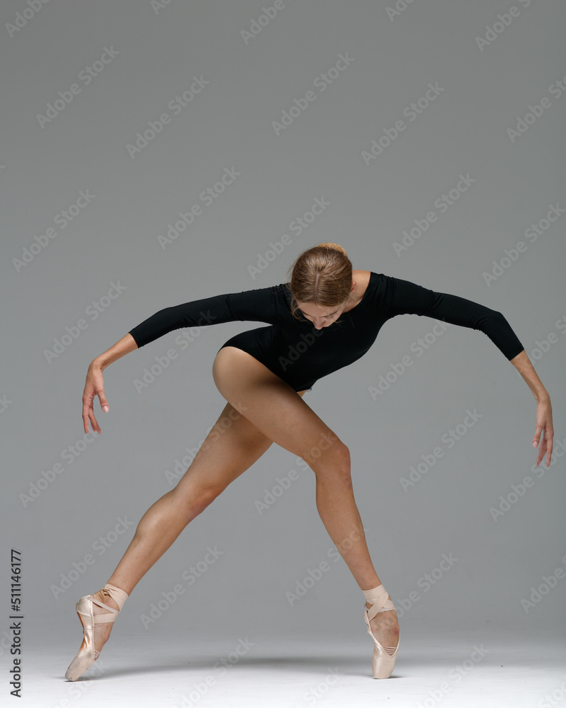 Young beautiful ballerina is posing in studio - obrazy, fototapety, plakaty 