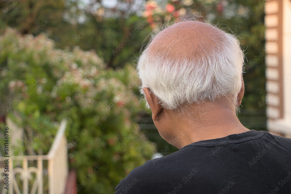 White haired unidentified senior male looking down from top with back pose