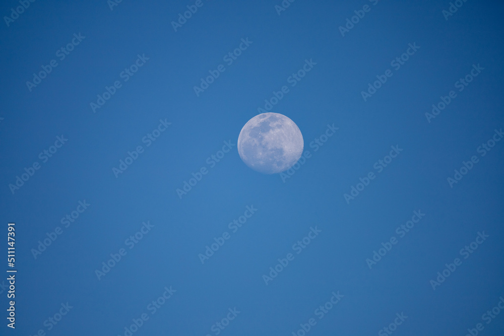 A blue full moon on a blue sky during the day in San Diego, California.