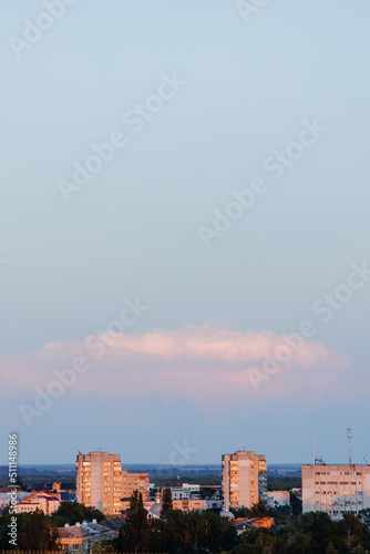  Beautiful sunset sky over the city. Twilight over the urban area. Aerial view. Typical modern residential area. Chernihiv. Ukraine. Vertical photo