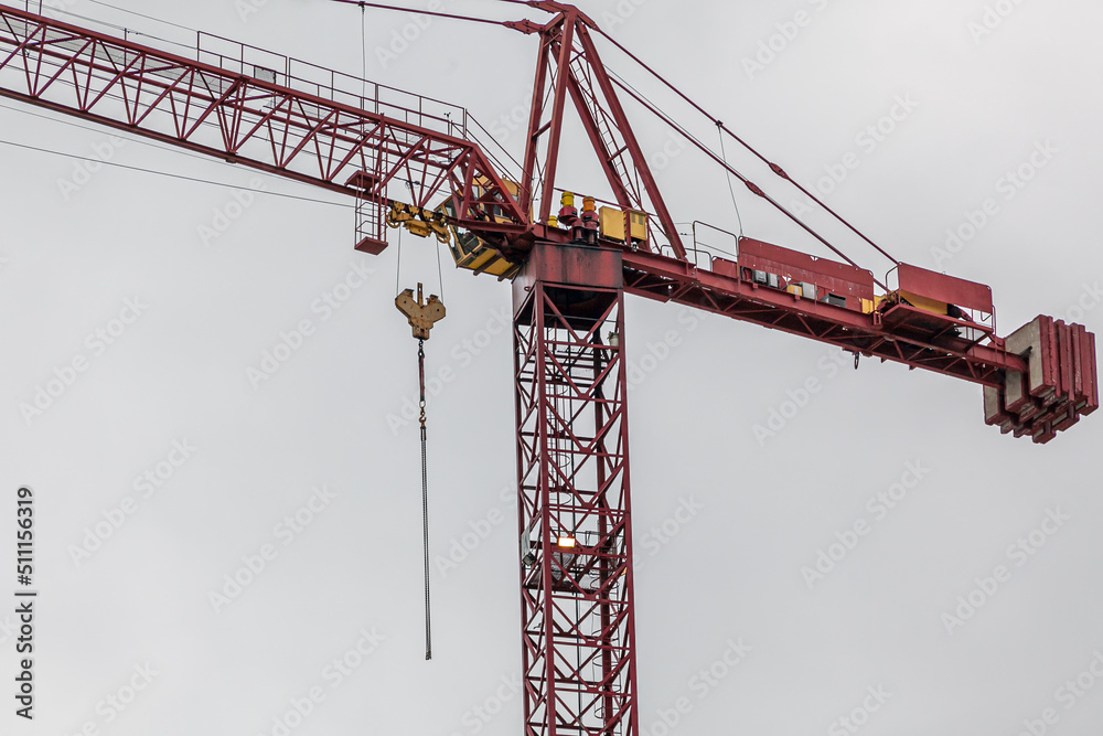 A tower crane against a white sky background A tower crane against a white sky background