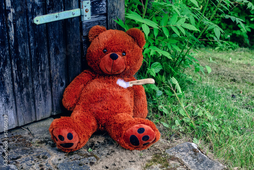 teddy bear lying on the floor destroyed with a knife