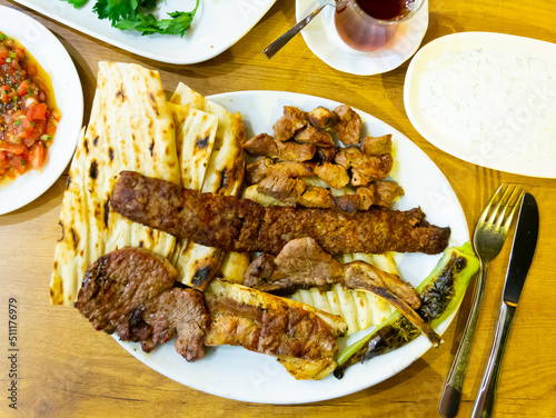 Kirmizi et tabagi. Plate with fried meat, pita bread and stewed peppers. Turkish cuisine photo