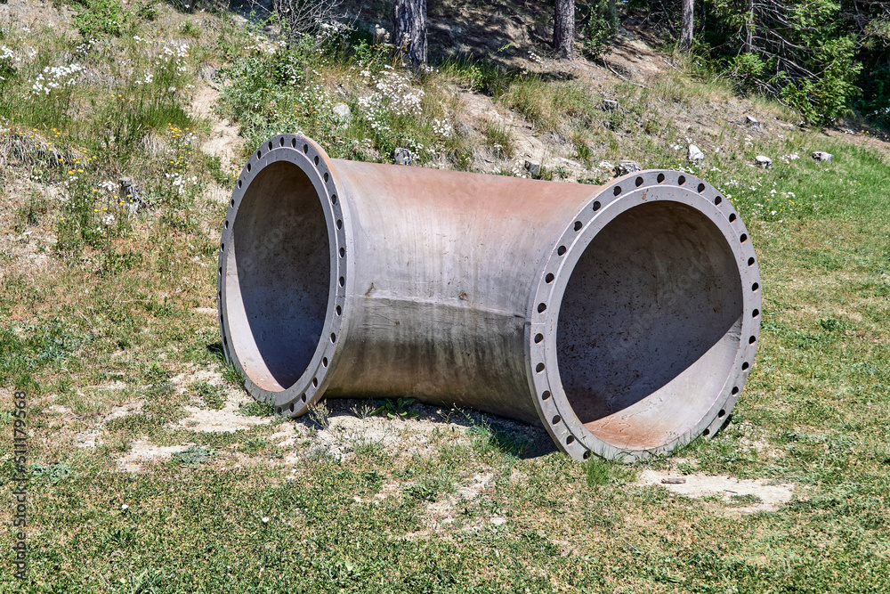 A gigantic old steel tube with a curved shape. Selective focus. A gigantic old steel tube with a curved shape. Selective focus.