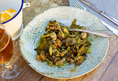 Lechecillas de ternasco. Roasted lamb gizzards served with stewed vegetables. Traditional spanish dish photo