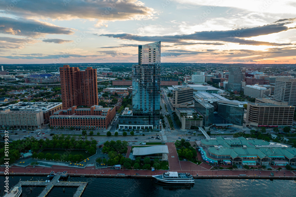Naklejka premium Aerial Drone View of Baltimore City Inner Harbor before Sunset with Blue Skies
