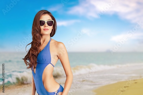 Young beautiful fit female model having fun at the sea at the beach