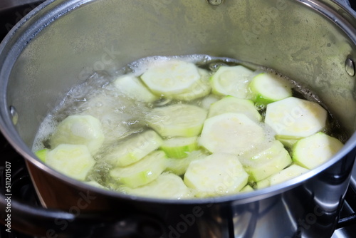 Slices of zucchini in the pot. Boiled vegetables, zucchini in a pan in hot water for blanching. Frozen Food Concept. It is called "Haslanmis Kabak" in Turkish. Diet or healthy food theme.