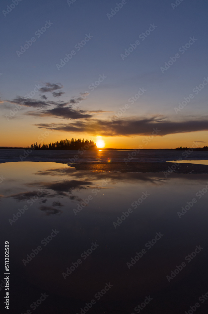 Evening Sunset over a Partially Frozen Lake