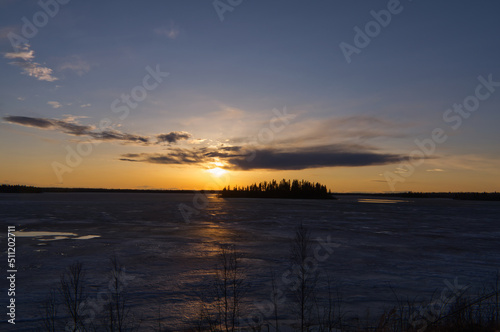 Evening Sunset over a Partially Frozen Lake