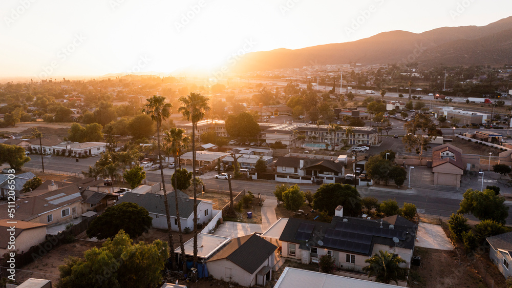 Sunset aerial view of the city and surrounding mountains of Jurupa Valley, California, USA.