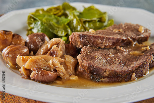 Roast beef with chestnuts and forest mushrooms and green peas. French gourmet food
