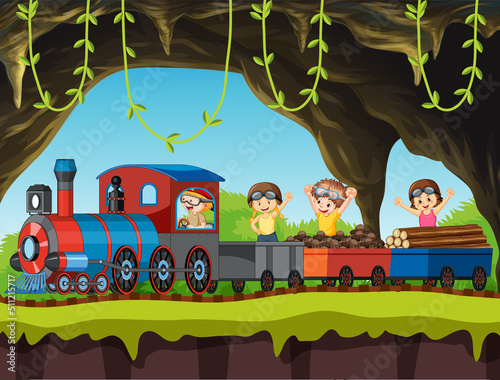 Children riding on train through the cave