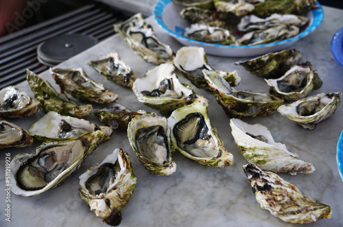 Fresh half oysters being prepped for a barbecue 