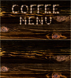 A menu of coffee drinks made from coffee beans on the background of a burnt board