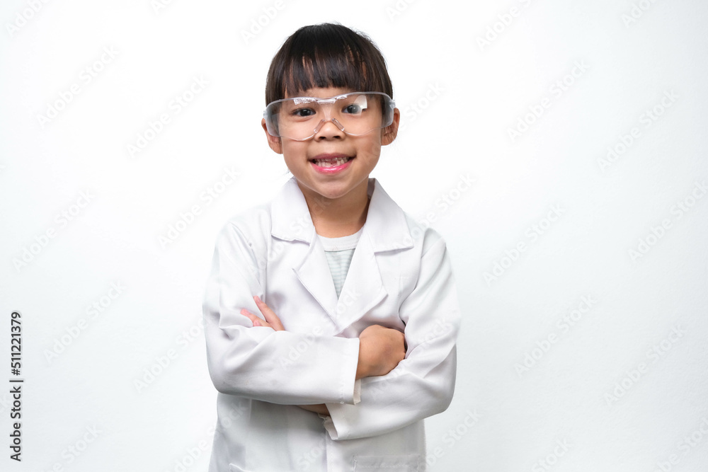 Portrait of a smiling little girl with glasses standing with her arms crossed in a doctor or science suit on a white background. Little scientist. Portrait of a smiling little girl with glasses standing with her arms crossed in a doctor or science suit on a white background. Little scientist.