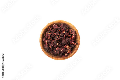 Dried hibiscus petals or Hibiscus sabdariffa in wooden bowl, top view. Karkade petals used to make herbal tea and delicious infusion photo