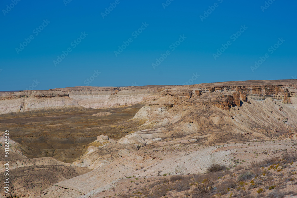 The amazing desert landscape background. Beautiful landscape of desert mountains. Monolithic mountains in desert. Stones and the sky. Bizarre sandstone cliffs in the desert.